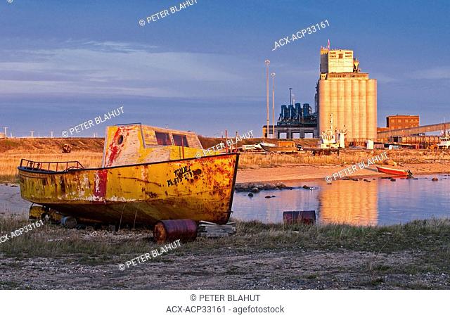 An old boat sits on the shore, Port of Churchill, Manitoba, Canada