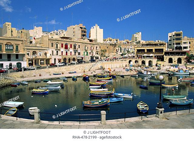 Boats and buildings on the waterfront at St. Julians Bay on the island of Malta, Mediterranean, Europe