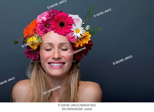 Young woman wearing garland of flowers on head