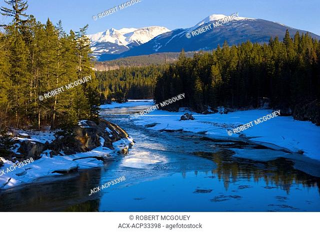 The snowy banks of the Fraser River on a sunny winter's day at Valemont, British Columbia, Canada