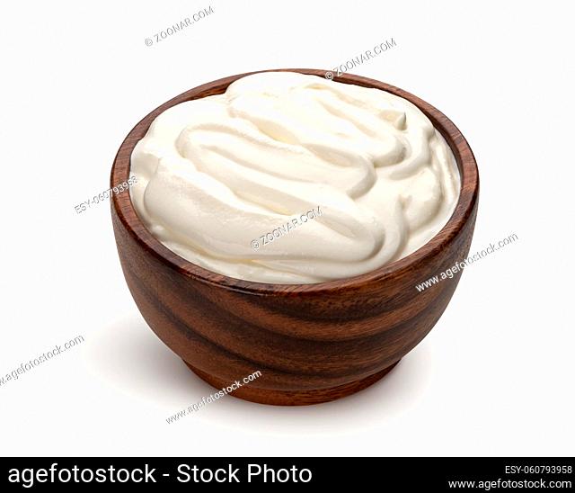 Sour cream in wooden bowl isolated on white background with clipping path