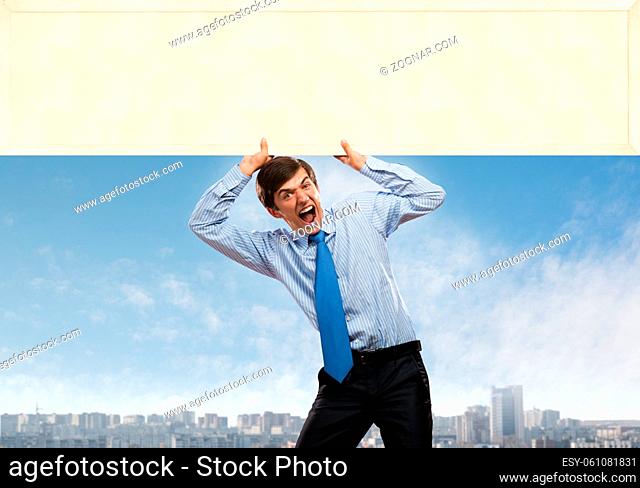 Emotional businessman lifting empty banner above his head