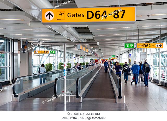 SCHIPHOL, THE NETHERLANDS - MAY 16, Travellers walking to the gate on May 16, 2016 at Schiphol Airport, The Netherlands