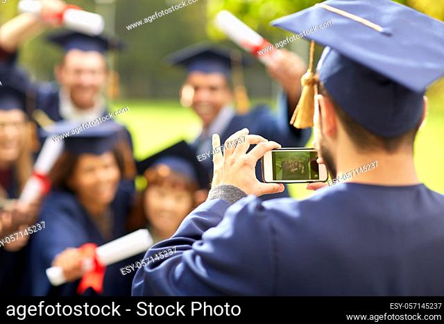 graduate students taking photo with smartphone