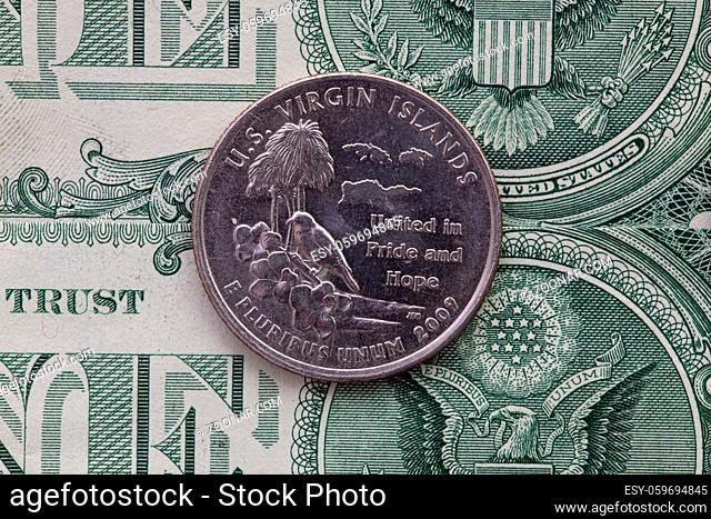 A quarter of U.S. Virgin Islands on US dollar bills. Symmetric composition of US dollar bills and a quarter of U.S. Virgin Islands