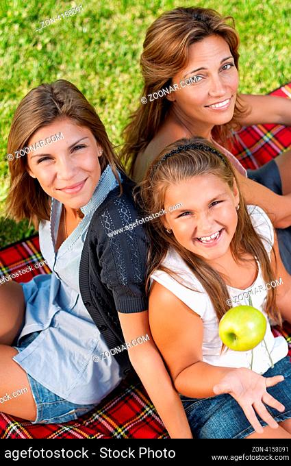 Happy mother with her daughters in park outdoors