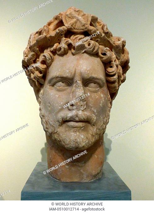 Colossal portrait head of the emperor Hadrian Ad 117-138. The emperor wears a wreath of oak leaves that end above his forehead in a medallion representing an...