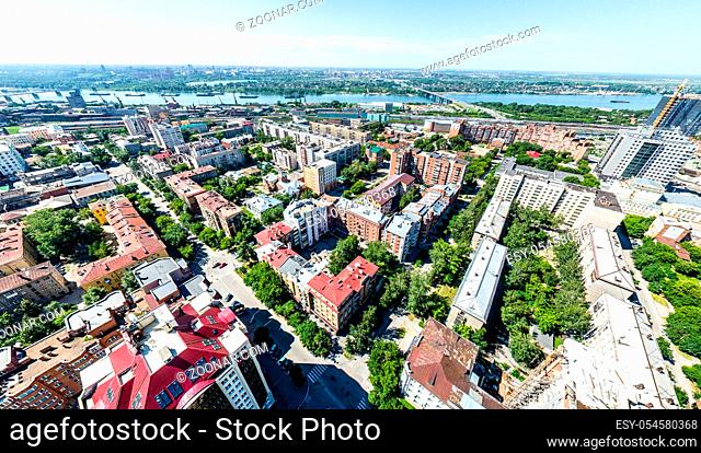 Aerial city view with crossroads, roads, houses, buildings, parks and parking lots. Copter drone helicopter shot. Panoramic wide angle image