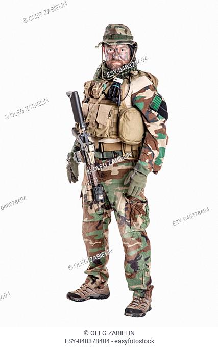 Special forces United States in Camouflage Uniforms studio shot. Holding weapons, wearing jungle hat, Shemagh scarf, his outfit clothes designed for jungle...