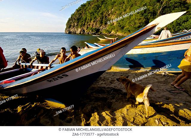 Pushing a fishermen's boat to the shore  Paria Peninsula, Eastern Venezuela