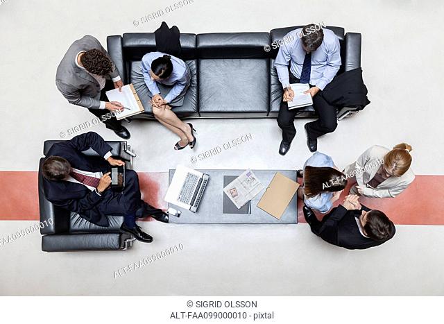 Executives in meeting, overhead view