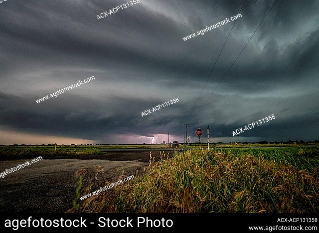 Tornado warned storm with lightning strikes over a rural field in Oklahoma United States