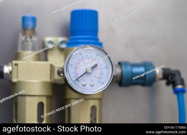 Equipment for washing compressed air, air gauge in the foreground. Pressure measuring equipment