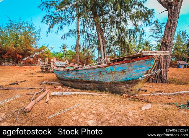 old wooden fisher boat on land , vintage fisherboat near beach