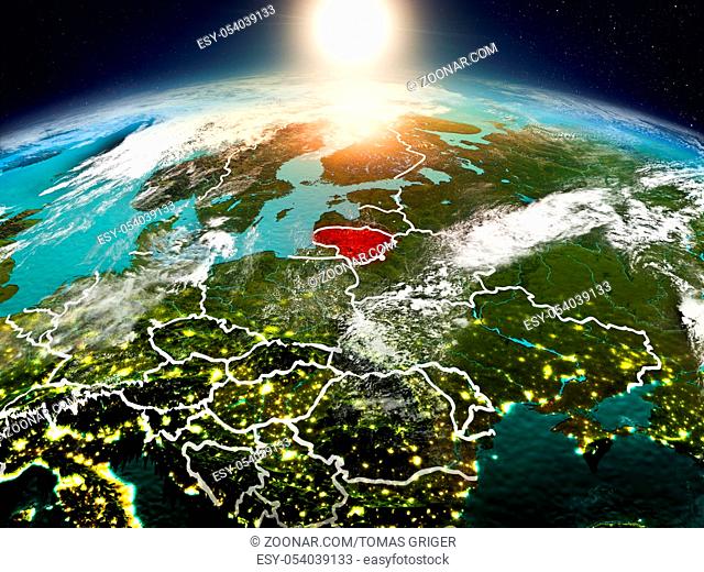 Sunrise above Lithuania highlighted in red on model of planet Earth in space with visible country borders. 3D illustration