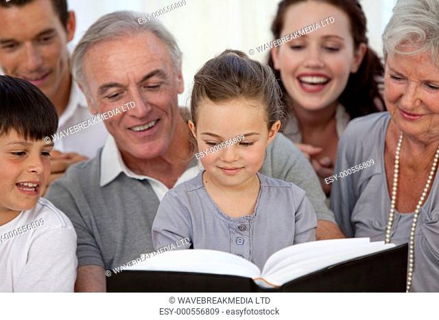 Close-up of family looking at a photograph album at home