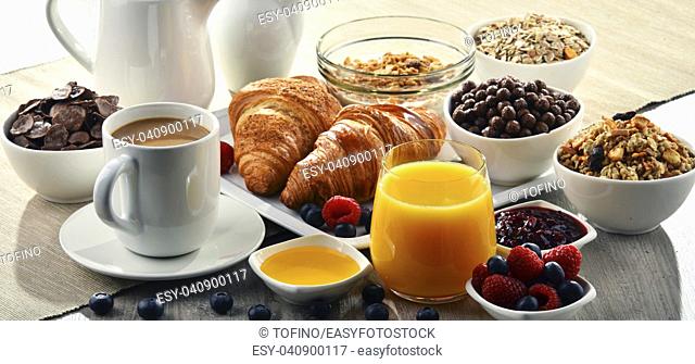 Breakfast served with coffee, orange juice, croissants, cereals and fruits. Balanced diet