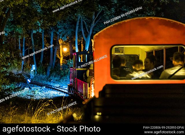 05 August 2022, Brandenburg, Cottbus: Passengers sit in a wagon during the so-called light rides of the Cottbus park railroad