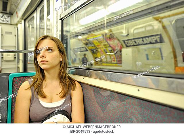 Young woman in Metro, Metro station with advertising, Paris, France, Europe