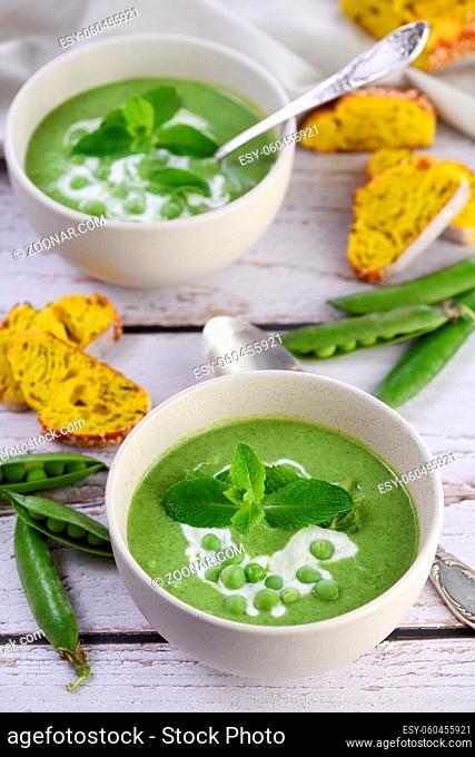 Chilled soup puree of green peas, seasoned with green onion, mint and crunchy toasted diced rusk bread