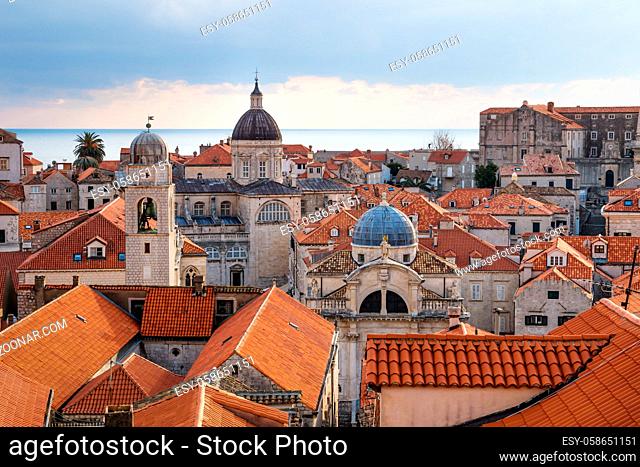 View over the orange roofs of old town Dubrovnik with church towers and ocean in winter, Croatia