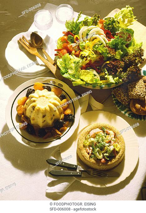 Wholefood meal: semolina, vegetables in sesame ring, salad