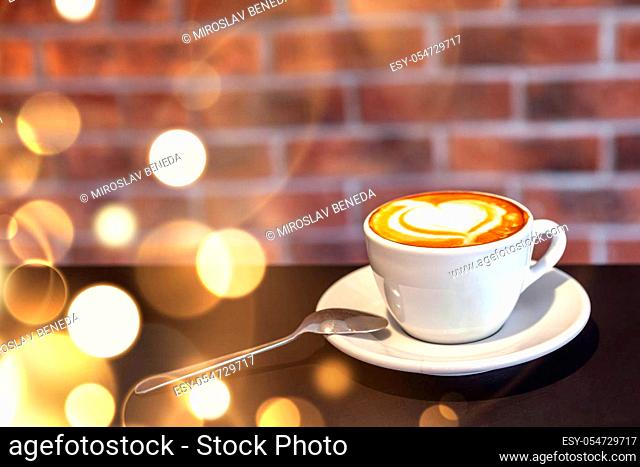 A cup of coffee on a with heart, valentines day, red wall, restaurant photo