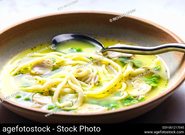 chicken broth with green peas and noodles
