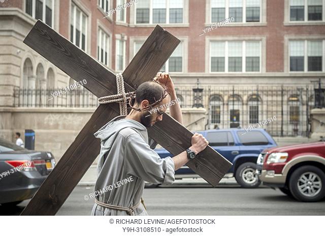 Parishioners and clergy members from the Franciscan Friars of the Renewal gather in Harlem in New York for their annual Way of the Cross Witness Walk on Good...