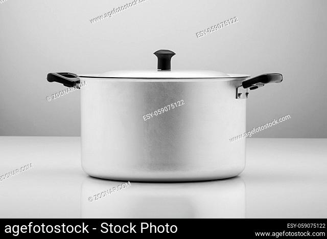 kitchen aluminum pan on light background with reflection
