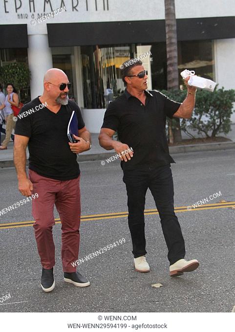Sylvester Stallone chats with a friend while crossing the street Featuring: Sylvester Stallone Where: Beverly Hills, California