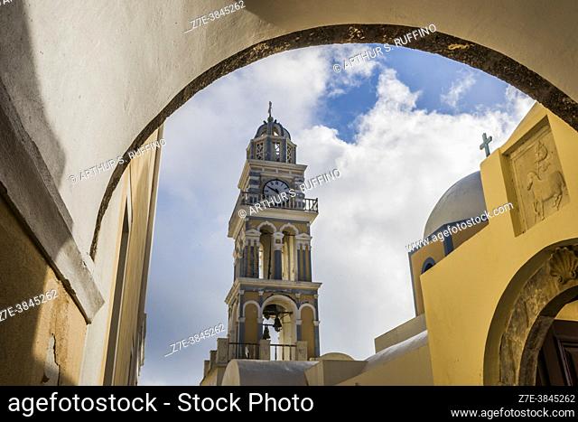 Clock tower of the Catholic Cathedral of Santorini (Cathedral of Saint John the Baptist). View through arch. Fira, Santorini, Greece, Europe