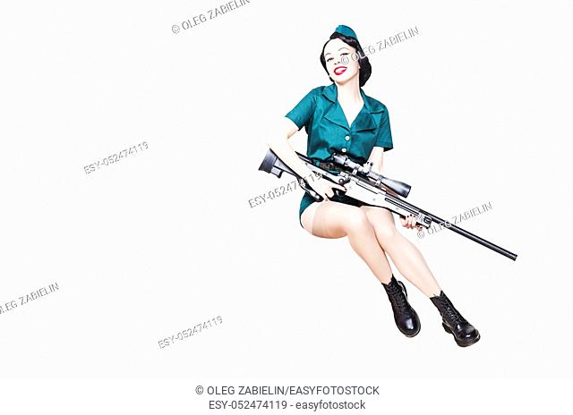 Portrait of Beautiful Brunette with black hair. Pin up Female Dressed in military clothing Uniform and Garrison cap with sniper rifle