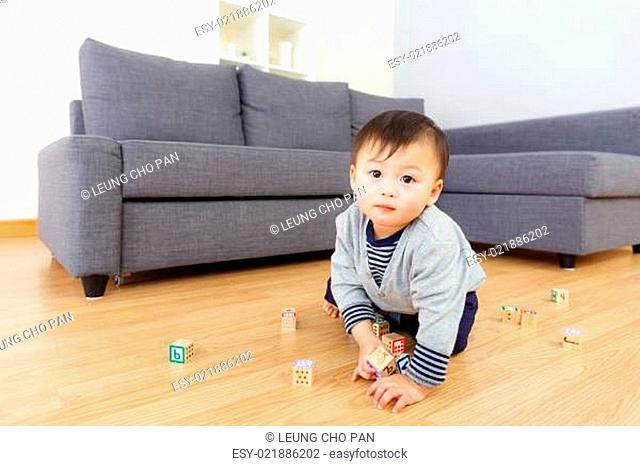 Aisa baby boy play toy block at home