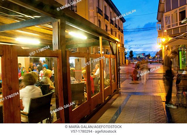 People in a restaurant, night view. Ribadesella, Asturias province, Spain