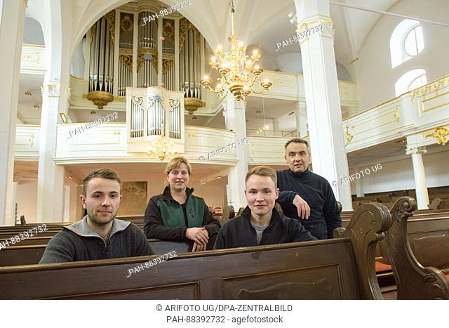 Sebastian (l-r), Kati, Tobias and Peter Speck from the Speck glasing company in the St. Peter and Paul Church in Weimar, Germany, 20 February 2017