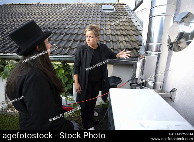 left to right Sandra KRINGS, master chimney sweep and building energy consultant, teaches the chimney of a stove, Mona NEUBAUR, Alliance 90/The Greens