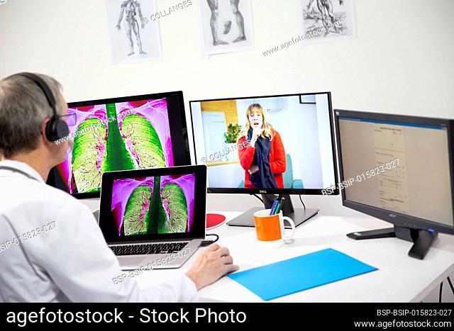 A GP during a video consultation looking at the x-ray of a woman’s lungs who has a lung infection