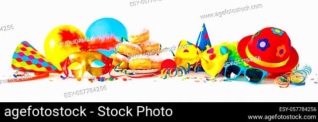 Colorful carnival or party background with donuts, balloons, streamers and confetti and funny face formed from wig, hat and eyeglasses isolated on white