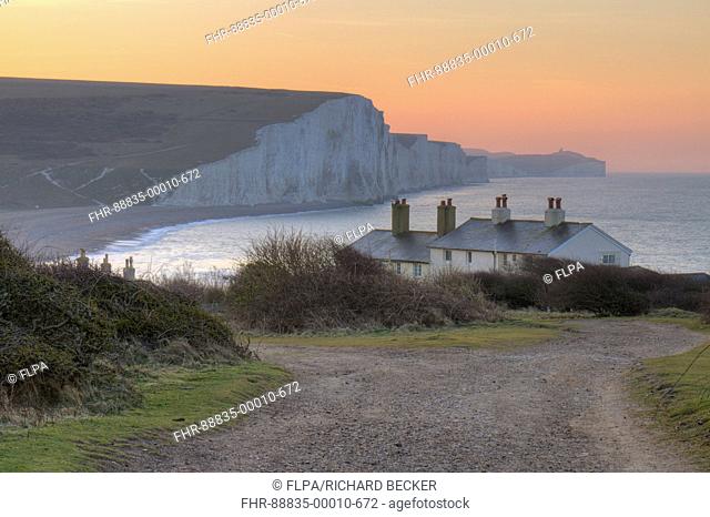 The Seven Sisters cliffs and coastguard cottages at dawn. From Seaford Head, South Downs, East Sussex, England. February