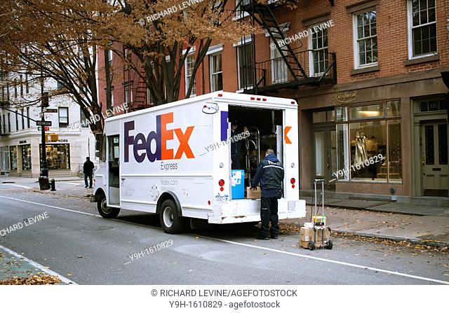 A FedEx employee sorts packages for delivery in Greenwich Village in New York