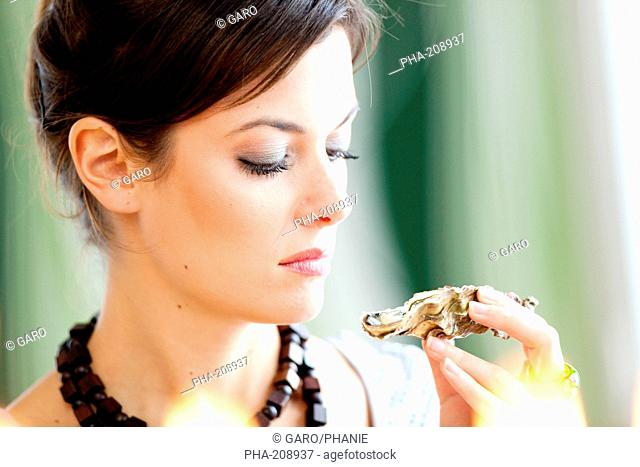 Woman smelling a rotten oyster