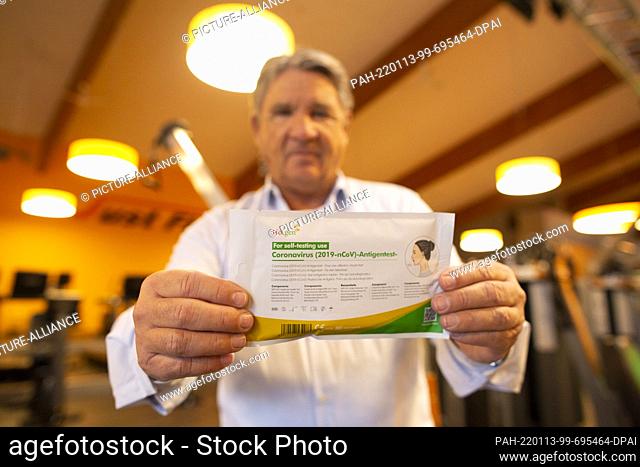 ILLUSTRATION - 13 January 2022, North Rhine-Westphalia, Frechen: Frank Böhme, founder and owner of Just Fit Group, holds a coronavirus (2019-nCoV) antigen test...