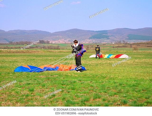 Two parachutes landed on the grass field