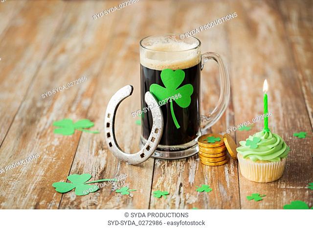 glass of beer, horseshoe, green cupcake and coins