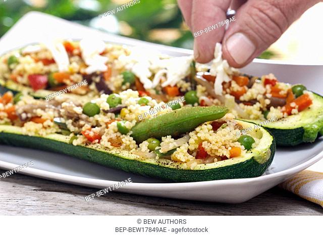Preparing zucchini stuffed with couscous vegetable salad
