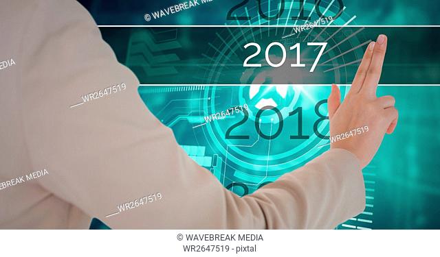 Hand of business woman touching 2017 in 3D digitally generated background
