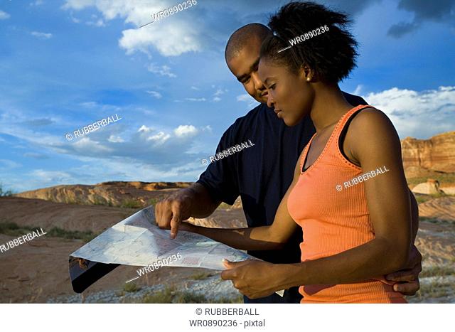 Profile of a young couple looking at a map