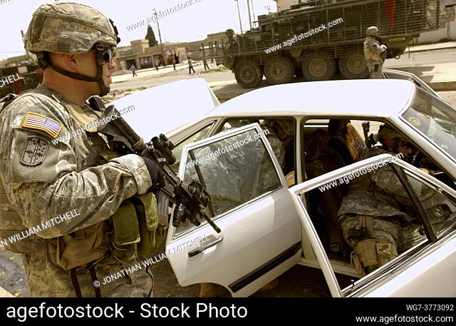 IRAQ Mosul -- 15 Apr 2006 -- US Army soldiers search a vehicle during a neighborhood patrol in Mosul, Iraq. The soldiers are with the 1st Battalion