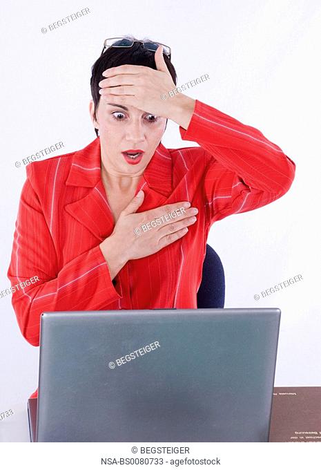 shocked business woman using laptop in office